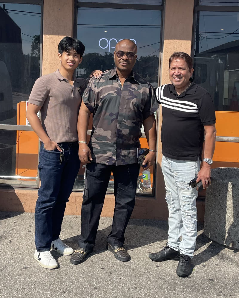Gerard Quasay, Okey Ezeh and Jonathan Hanif, left to right, standing outside a restaurant in Toronto